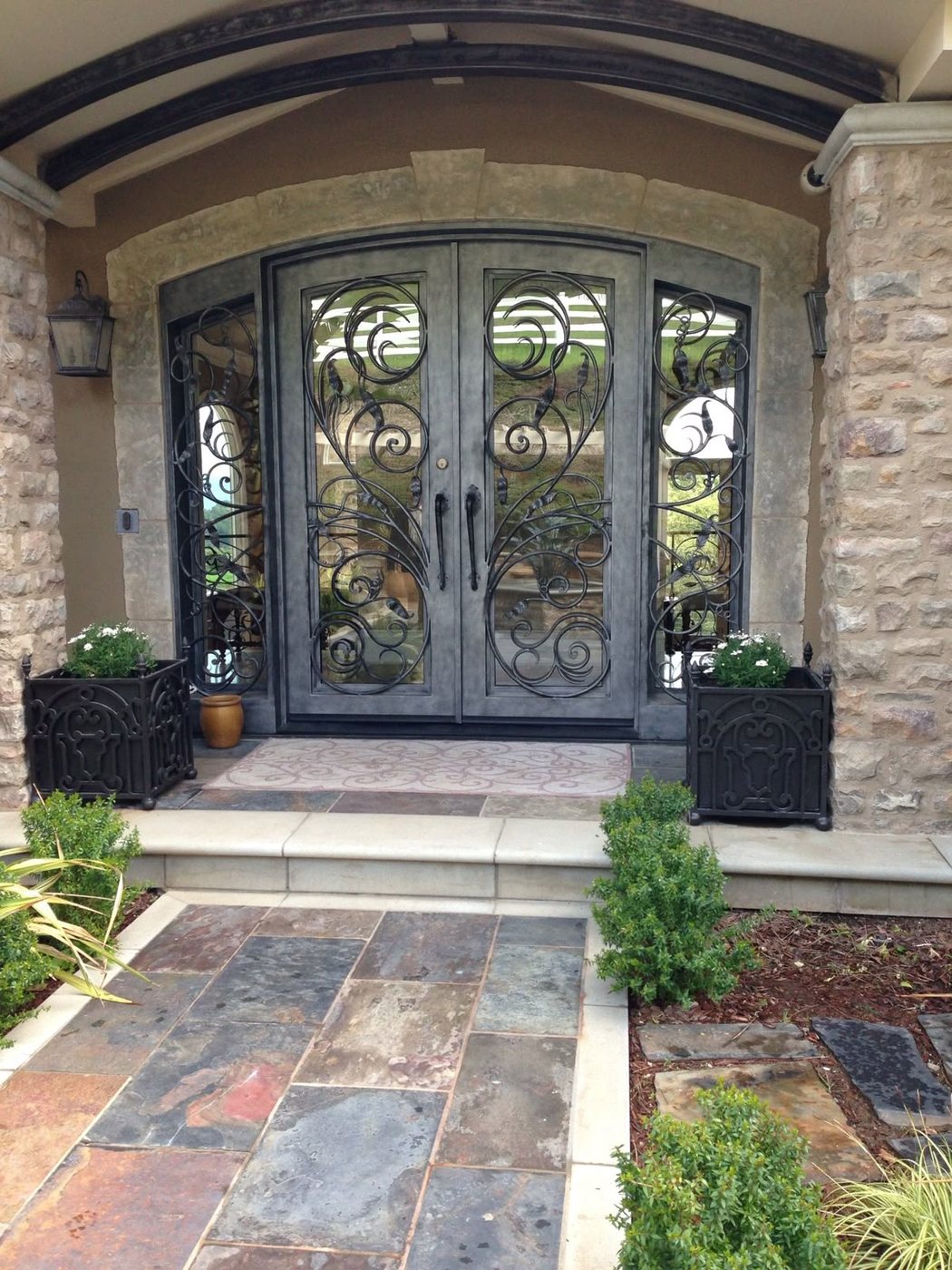 Wrought iron entry door with scrollwork, installed