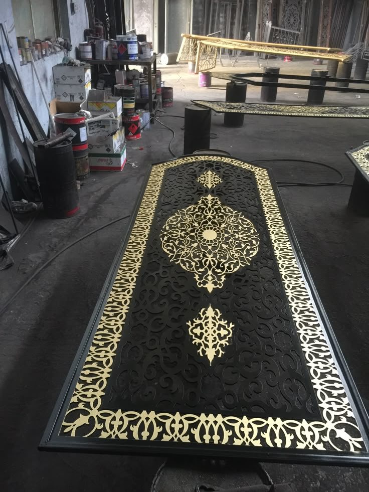 Laser-cut panel in gold and black finished on the shop floor