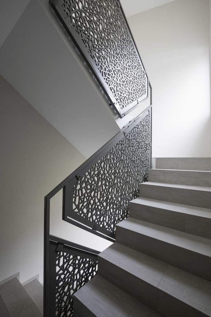 Laser-cut steel art panels along a staircase